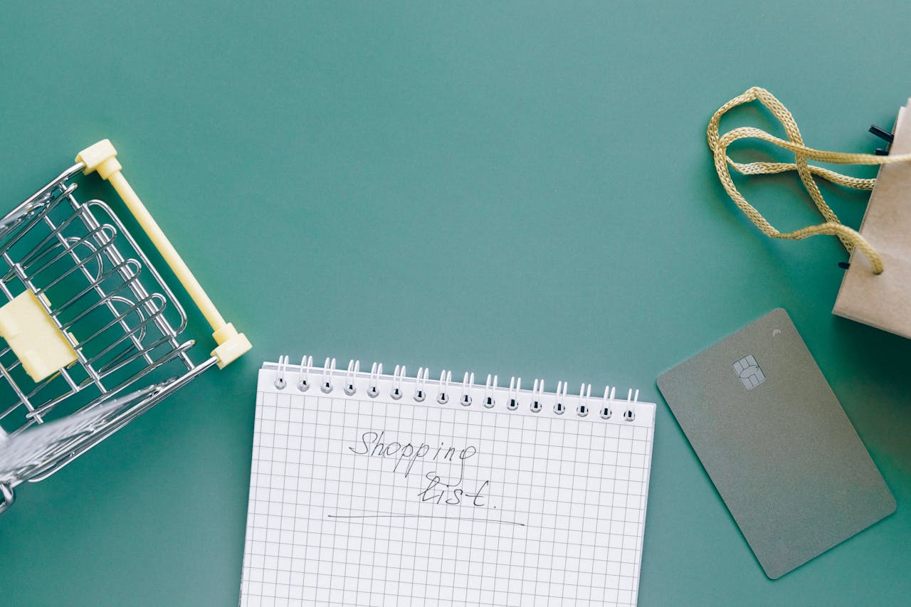 Services-03 A top-down view of a shopping cart, list, card, and bag on a green background.